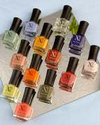 Xprss Nail Polish collection with multiple colorful bottles arranged with flowers and candles